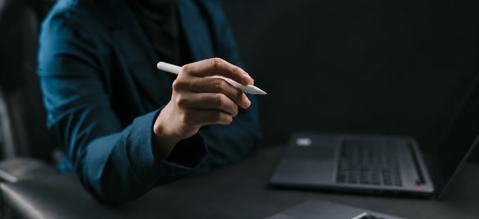 A professional working at a desk with a laptop